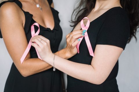 2 Women Holding Pink Ribbons